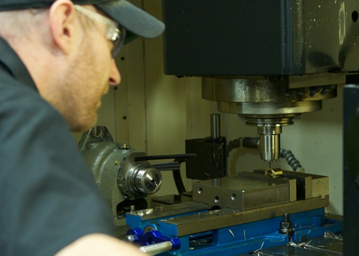 Shamrock Precision worker pic he doing his work. Precision Machining in Texas