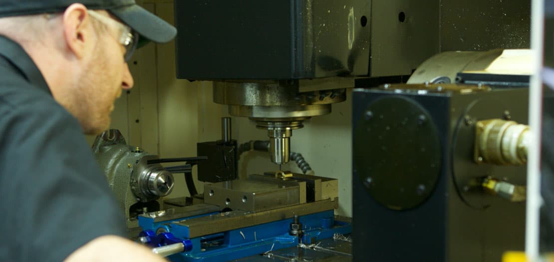 Shamrock Precision's machinist working on CNC machines