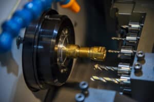 A detailed view of a sliding headstock on a CNC lathe illustrating what is Swiss machining