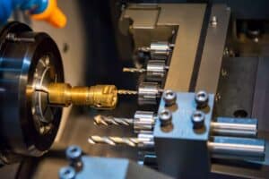 CNC Swiss machining operator setting up tooling for high-volume production