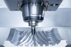 Advanced multi-axis CNC spindle performing 7-axis machining on a complex turbine blade